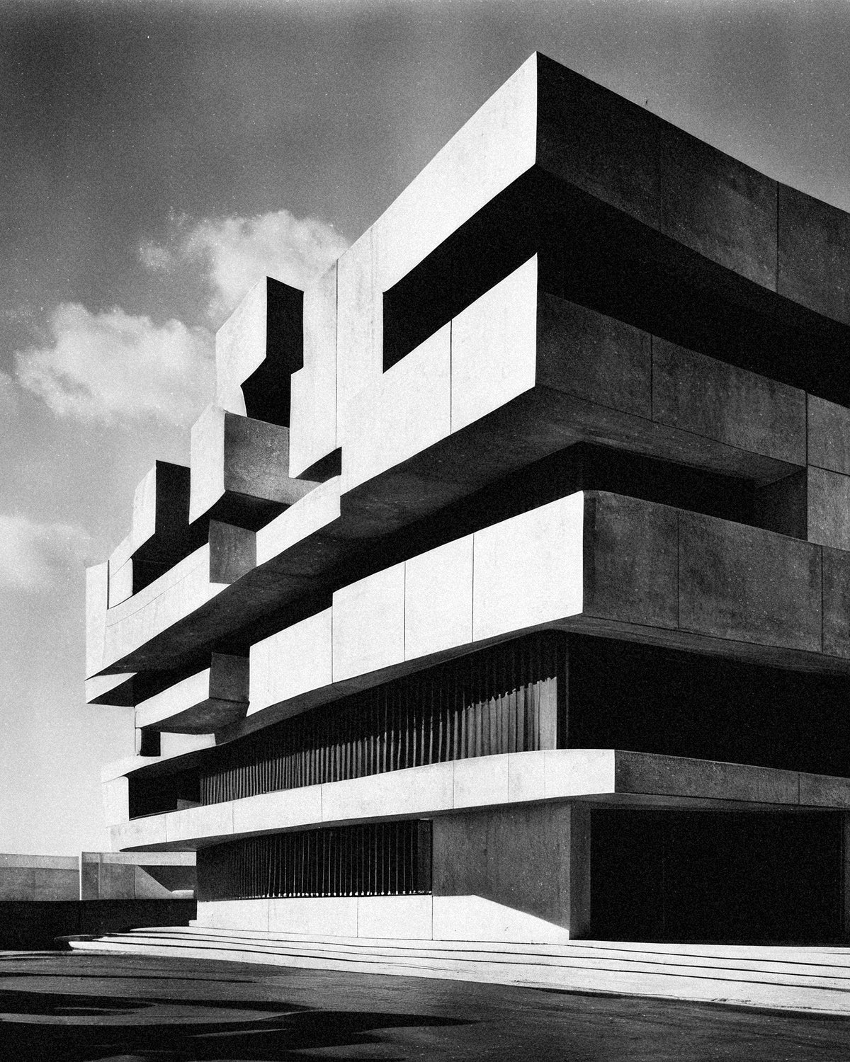 Black-and-white image of a monumental brutalist concrete building with stacked, cantilevered horizontal blocks under a cloudy sky