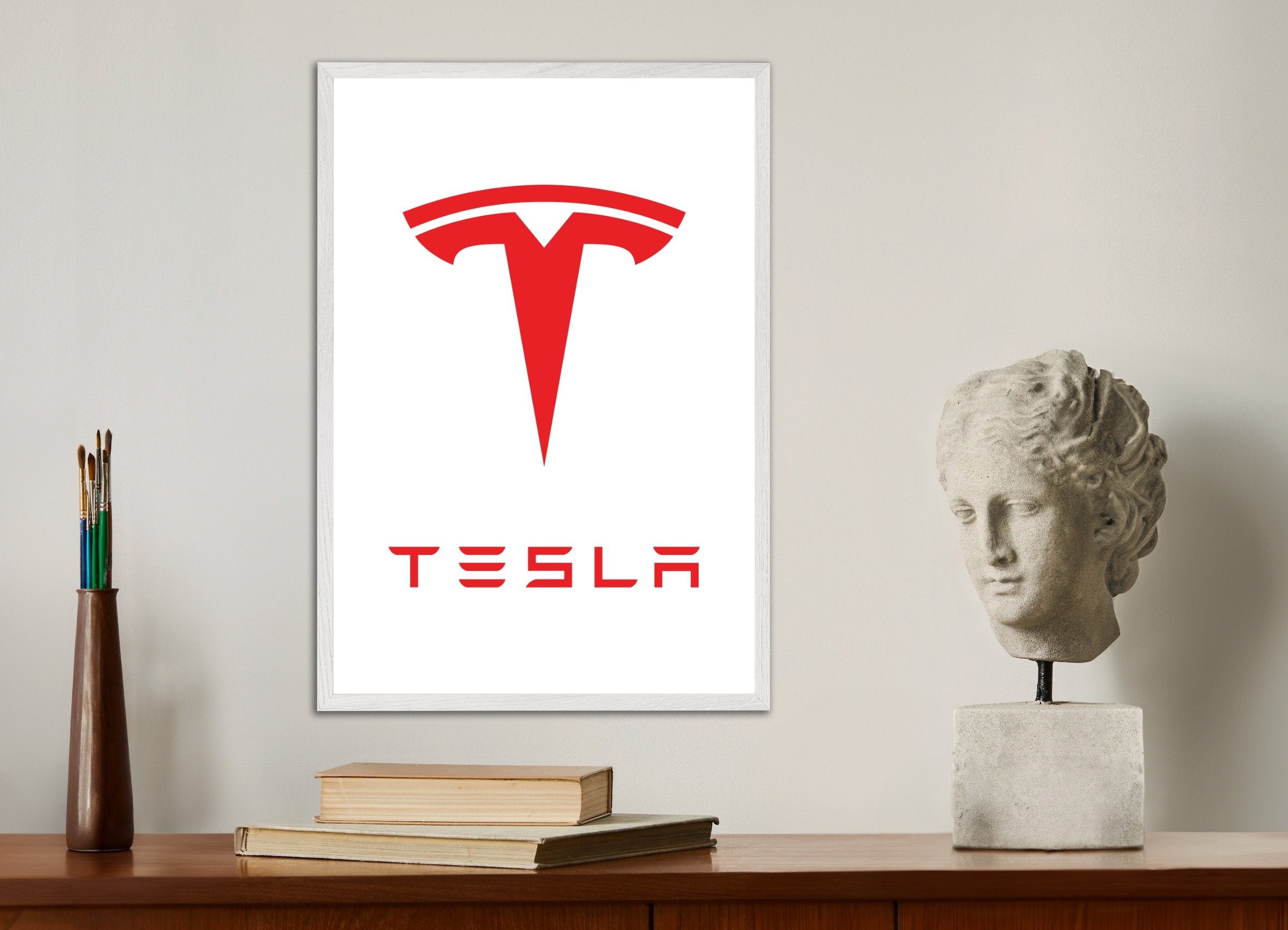 Poster of Tesla logo, with white wooden frame